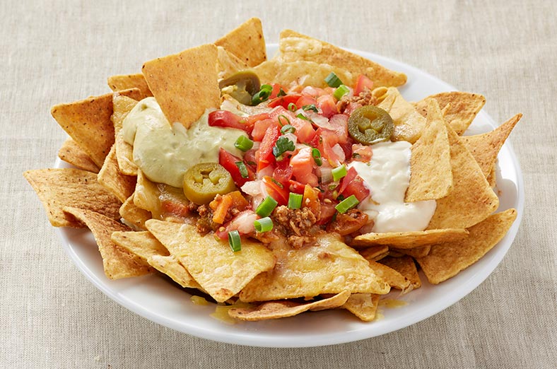 Nachos, guacamole, sour cream, salad